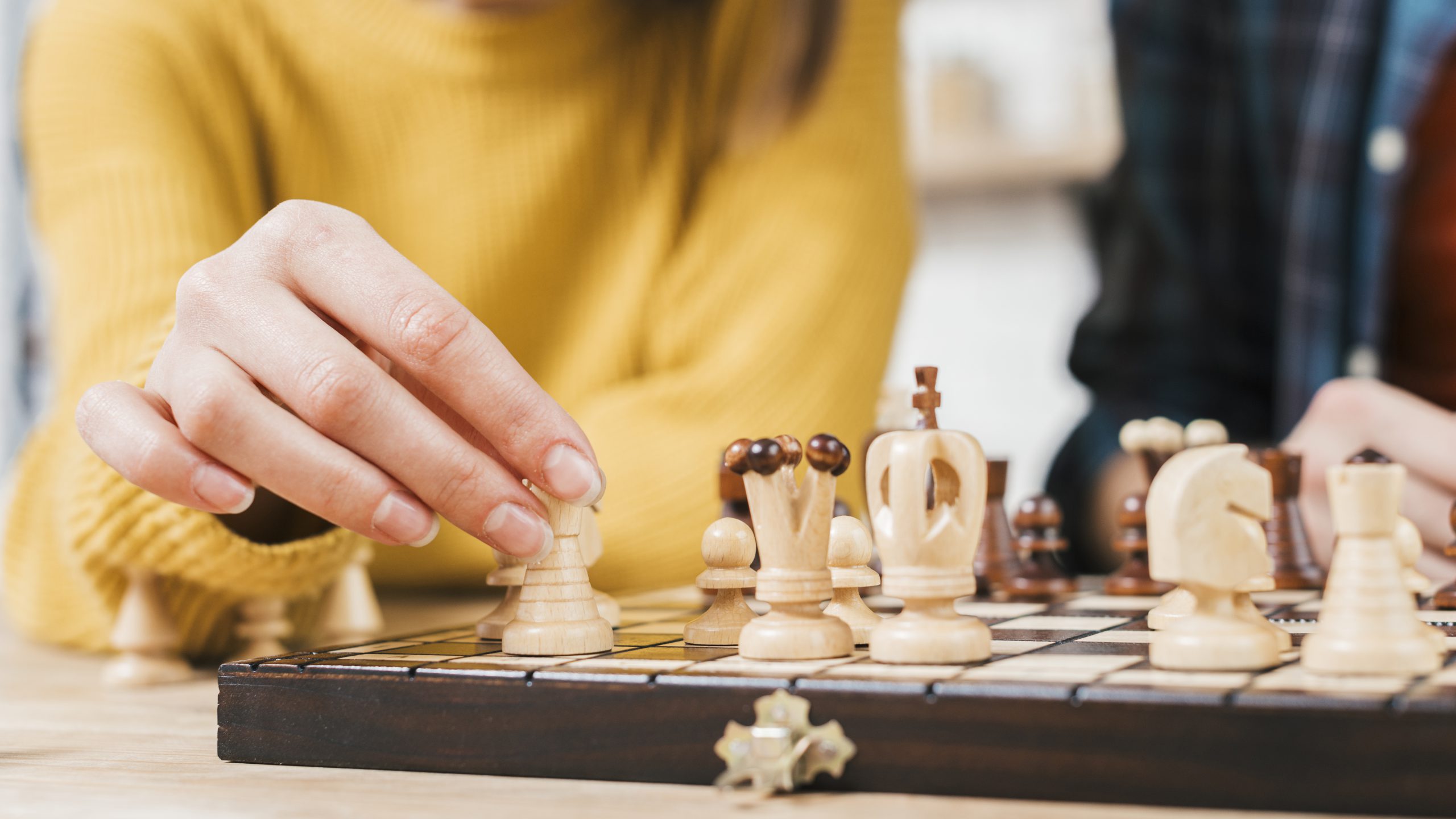 close-up-young-woman-playing-chess-board-game